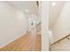 Hallway with light wooden floors, stairs, and plenty of natural light at 163 Windy Dell Dr, Tega Cay, SC 29708