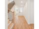 Hallway featuring hardwood floors and a staircase with natural wood and black metal railings at 163 Windy Dell Dr, Tega Cay, SC 29708