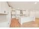 Modern kitchen featuring white cabinets, stainless steel appliances, a center island, and hardwood floors at 163 Windy Dell Dr, Tega Cay, SC 29708