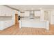 A modern kitchen with white cabinets, stainless steel appliances, and a large center island at 163 Windy Dell Dr, Tega Cay, SC 29708