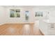 A bright living room with hardwood floors and views of the kitchen, large windows, and an outdoor balcony at 163 Windy Dell Dr, Tega Cay, SC 29708