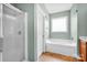 Fresh bathroom features a tub, a separate shower, and a double door at 16606 Spruell St, Huntersville, NC 28078