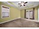 Spacious bedroom features trey ceilings, neutral carpet, and door to porch at 16606 Spruell St, Huntersville, NC 28078