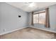 Cozy bedroom features a ceiling fan, a window, and neutral carpeting at 16606 Spruell St, Huntersville, NC 28078