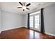 Light-filled bedroom features wood floors, neutral paint, and french doors to the outside at 16606 Spruell St, Huntersville, NC 28078