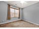 Bedroom with a ceiling fan, a window with blinds, and neutral carpeting at 16606 Spruell St, Huntersville, NC 28078