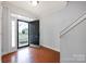 Bright foyer features hardwood floors, fresh paint, and an exterior door at 16606 Spruell St, Huntersville, NC 28078
