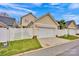 Detached garage with white fence, set in landscaped yard, offers privacy and appeal at 16606 Spruell St, Huntersville, NC 28078