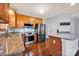 Kitchen featuring stainless steel appliances, granite countertops and wooden cabinets at 16606 Spruell St, Huntersville, NC 28078