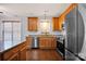 Kitchen featuring stainless appliances, double window, wooden cabinets, granite countertops at 16606 Spruell St, Huntersville, NC 28078