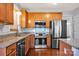 Well-equipped kitchen features stainless steel appliances, granite countertops, and wooden cabinets at 16606 Spruell St, Huntersville, NC 28078