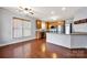 Bright kitchen featuring stainless steel appliances, granite countertops, and hardwood floors at 16606 Spruell St, Huntersville, NC 28078