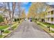 A charming street view showcasing well-maintained lawns, trees, and neatly lined houses in the neighborhood at 16606 Spruell St, Huntersville, NC 28078