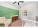 Stylish Bedroom with crib, dresser, and a cozy armchair, perfect for a modern and comfortable space at 253 W G St, Kannapolis, NC 28081