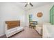 Bedroom with crib, armchair, and decorative bookshelf providing storage space at 253 W G St, Kannapolis, NC 28081