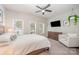 Bright bedroom with large windows, television, and comfy armchair perfect for relaxation at 253 W G St, Kannapolis, NC 28081