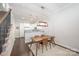 Dining area with hardwood floors, a stylish pendant light, and access to the kitchen at 253 W G St, Kannapolis, NC 28081