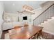 Open-concept dining area featuring hardwood floors, a statement chandelier and stair access at 253 W G St, Kannapolis, NC 28081