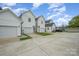 Exterior view highlighting garages and driveways in front of townhomes at 253 W G St, Kannapolis, NC 28081