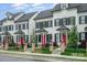 Charming townhomes featuring black shutters, red doors, and well-maintained landscaping at 253 W G St, Kannapolis, NC 28081