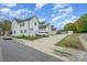 White townhomes with private driveways, garages, and black trim at 253 W G St, Kannapolis, NC 28081
