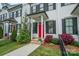 Charming townhouse front entrance with a vibrant red door and manicured landscaping at 253 W G St, Kannapolis, NC 28081