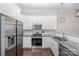 Well-lit kitchen with white cabinets, granite countertops, and stainless steel appliances at 253 W G St, Kannapolis, NC 28081