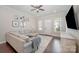 Inviting living room featuring a large sectional sofa, neutral rug, and bright natural light at 253 W G St, Kannapolis, NC 28081