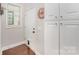 Mudroom with hardwood flooring, exterior access, custom cabinets, and light gray walls at 253 W G St, Kannapolis, NC 28081