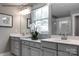 Bright bathroom featuring double vanity with white quartz countertops, framed mirrors, and a large window at 3010 Bramble Hedge Rd # 3271, Indian Trail, NC 28079