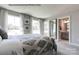 Bedroom with large windows, ensuite bathroom, plush carpet, and a decorative, full-length mirror at 3010 Bramble Hedge Rd # 3271, Indian Trail, NC 28079