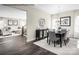 Open-concept dining room with modern chandelier, dark table, six chairs and access to a living room space at 3010 Bramble Hedge Rd # 3271, Indian Trail, NC 28079