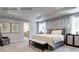 Serene main bedroom features a tray ceiling, soft carpet, elegant decor, and an ensuite bathroom at 3010 Bramble Hedge Rd # 3271, Indian Trail, NC 28079