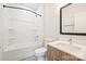 Bright bathroom showcases a tub and shower combo, vanity, and wood-look cabinets at 3011 Yada Ln, Charlotte, NC 28208