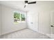 Minimalist bedroom with natural light, carpet flooring, and a ceiling fan at 3011 Yada Ln, Charlotte, NC 28208