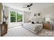 Bright bedroom features a large window, neutral tones, and a modern ceiling fan at 3011 Yada Ln, Charlotte, NC 28208
