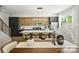 Modern kitchen features stainless appliances, contrasting cabinets, and a large island with seating at 3011 Yada Ln, Charlotte, NC 28208