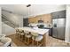 Modern kitchen features stainless appliances, contrasting cabinets, and a large island with seating at 3011 Yada Ln, Charlotte, NC 28208