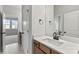 Bathroom with white countertops, tiled floors, and modern bronze fixtures with a view to the bedroom at 3050 Tramore Dr, Harrisburg, NC 28075