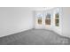 Light-filled bedroom with large windows and neutral carpeting, offering a serene atmosphere at 3057 Tramore Dr, Harrisburg, NC 28075