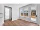 Airy dining area with hardwood floors, large windows, and access to an outdoor space at 3057 Tramore Dr, Harrisburg, NC 28075