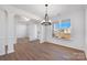 Elegant dining room with hardwood floors, wainscoting, and large windows offering neighborhood views at 3057 Tramore Dr, Harrisburg, NC 28075