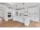 Open-concept kitchen with white cabinets, stainless steel appliances, and a large center island at 3057 Tramore Dr, Harrisburg, NC 28075
