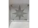 Close-up of a tile featuring a starburst design; gray pattern on a light background at 3057 Tramore Dr, Harrisburg, NC 28075