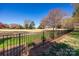 Beautiful home backyard features a well-manicured lawn and black metal fence for added privacy and security at 315 Muirfield Way, Salisbury, NC 28144