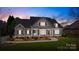 Charming gray two-story home with landscaped front yard and inviting entrance at twilight at 315 Muirfield Way, Salisbury, NC 28144