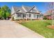Charming home with a well-manicured lawn, a long driveway, and lush landscaping at 315 Muirfield Way, Salisbury, NC 28144