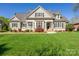 Attractive home with a manicured lawn, neutral siding, dark shutters, and a welcoming entrance at 315 Muirfield Way, Salisbury, NC 28144