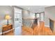 Well-lit hallway with hardwood floors, decorative staircase, and open views to other rooms at 315 Muirfield Way, Salisbury, NC 28144