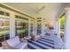 Relaxing covered porch with comfortable seating and a view of the surrounding landscape at 315 Muirfield Way, Salisbury, NC 28144
